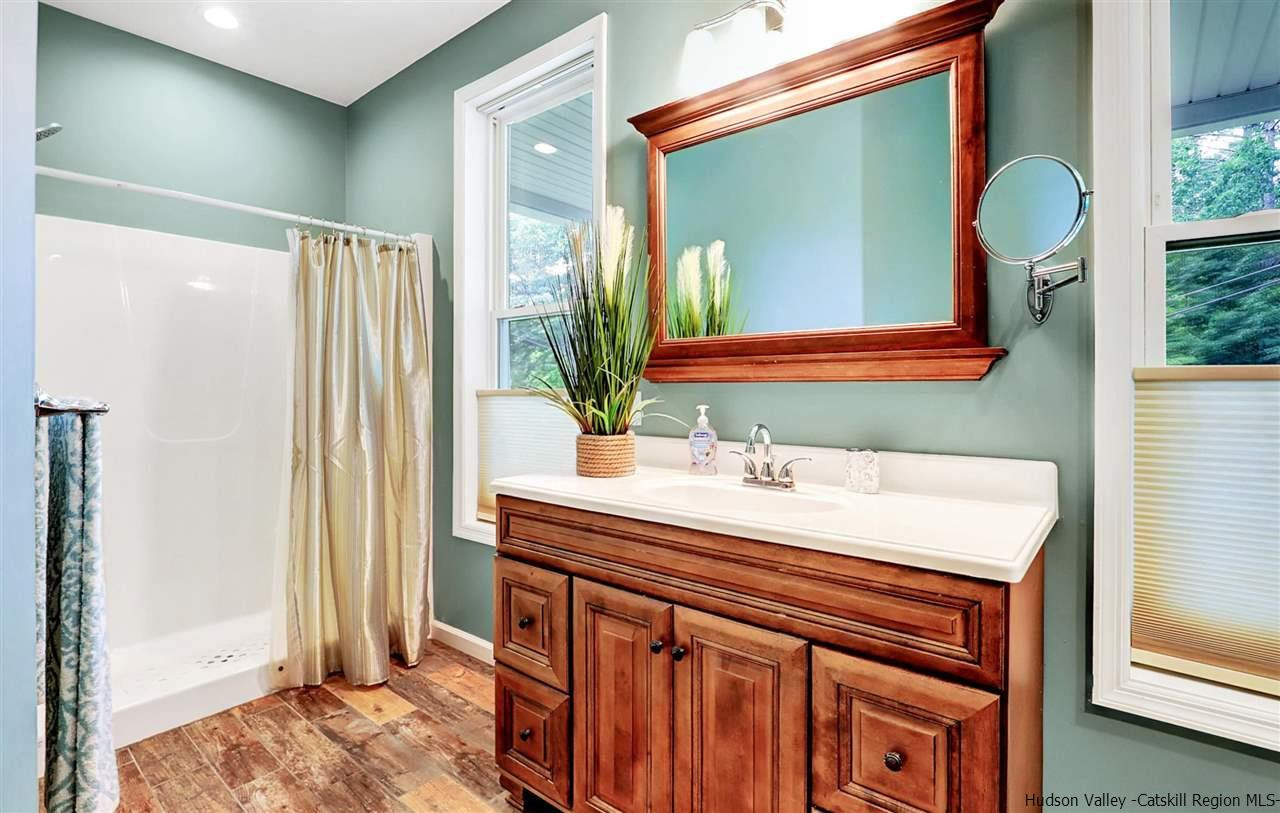 194 Harry Wells Road Saugerties, NY 12477 - Photo 26 of 35 a bathroom with a sink vanity and a mirror