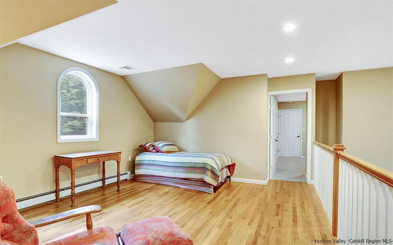 194 Harry Wells Road Saugerties, NY 12477 - Photo 28 of 35 a bedroom with a bed and wooden floor