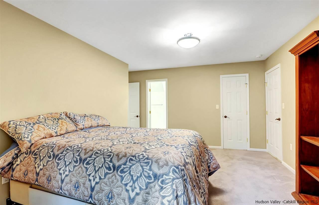 194 Harry Wells Road Saugerties, NY 12477 - Photo 30 of 35 a bedroom with a bed and a painting on the wall