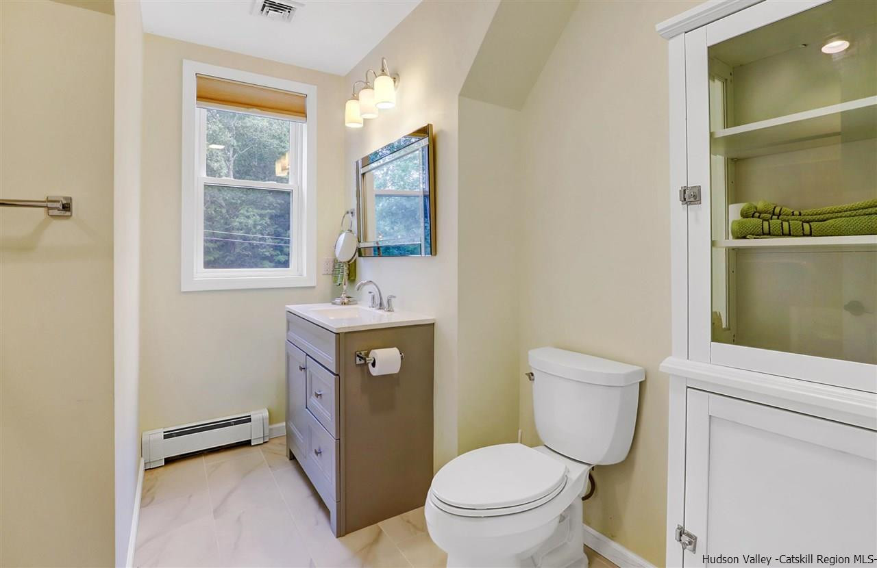 194 Harry Wells Road Saugerties, NY 12477 - Photo 31 of 35 a bathroom with a toilet sink and mirror