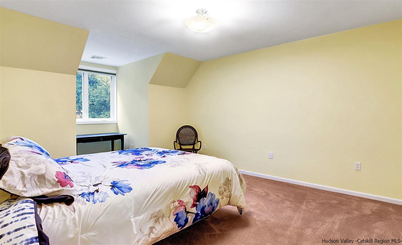 194 Harry Wells Road Saugerties, NY 12477 - Photo 32 of 35 a bedroom with a bed and dresser