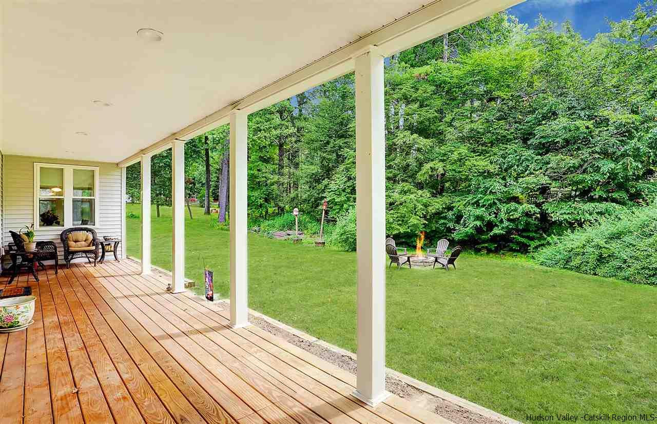 194 Harry Wells Road Saugerties, NY 12477 - Photo 6 of 35 a view of a living room and hardwood floor to ceiling window and wooden fence
