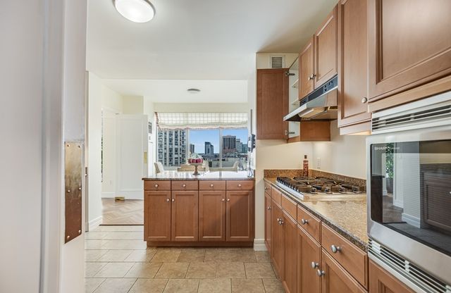 a kitchen with stainless steel appliances granite countertop a stove and a sink