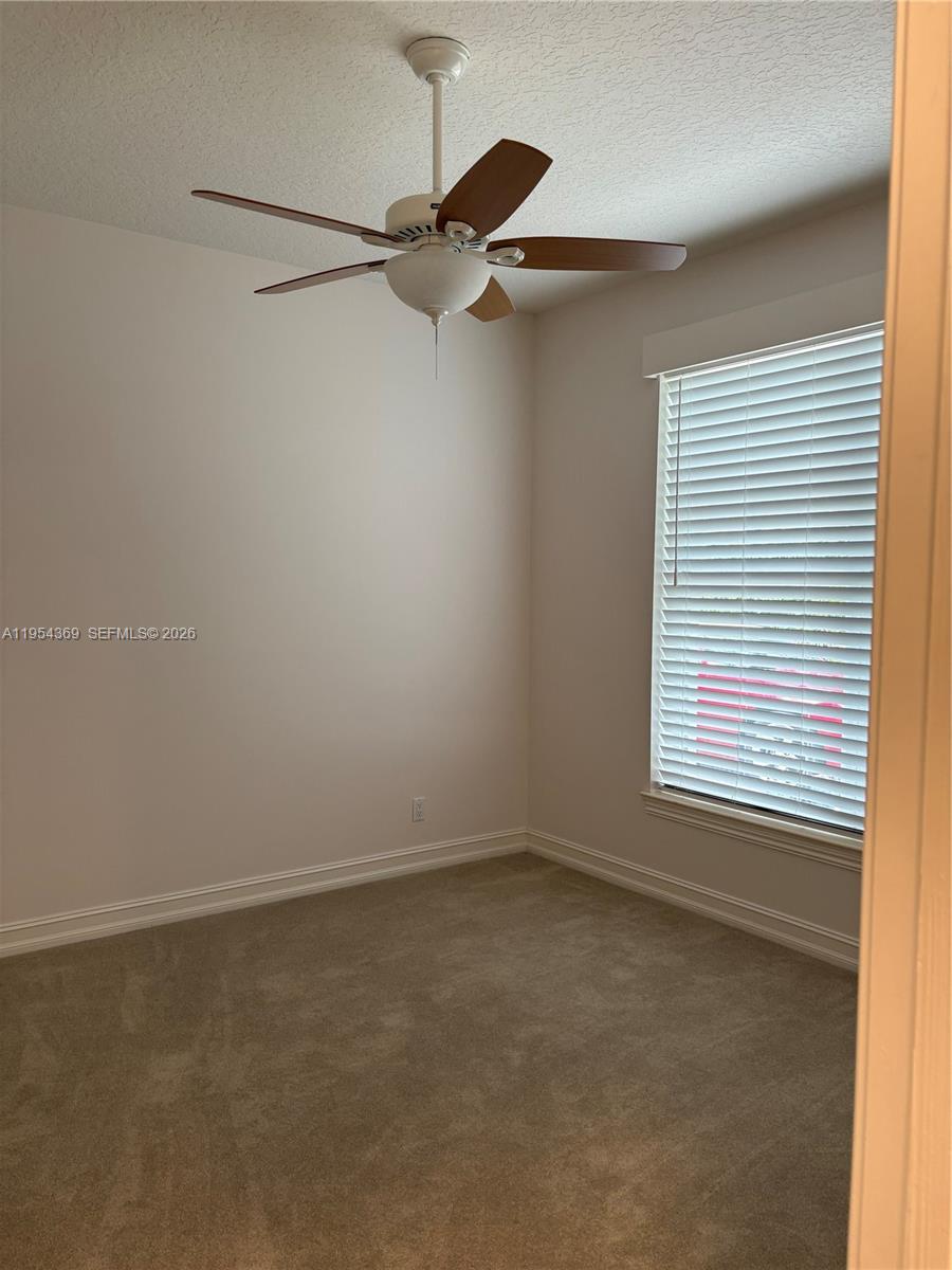 18265 Southeast Ridgeview Drive Tequesta, FL 33469 - Photo 14 of 15 an empty room with a window and a fan
