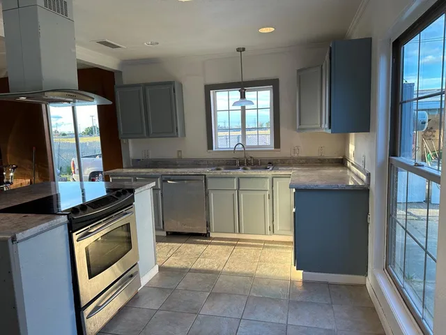 a kitchen with a stove sink and refrigerator