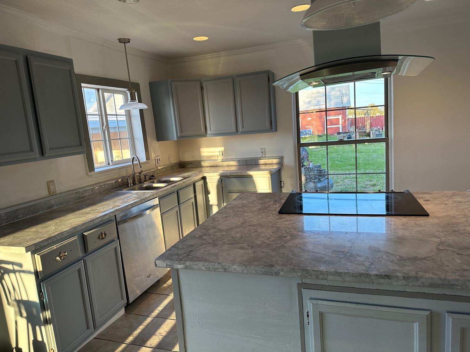 7271 Elk Grove Florin Road Sacramento, CA 95829 - Photo 16 of 49 a kitchen with kitchen island granite countertop a stove a sink and a microwave