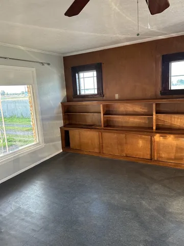 a living room with furniture and a dining table