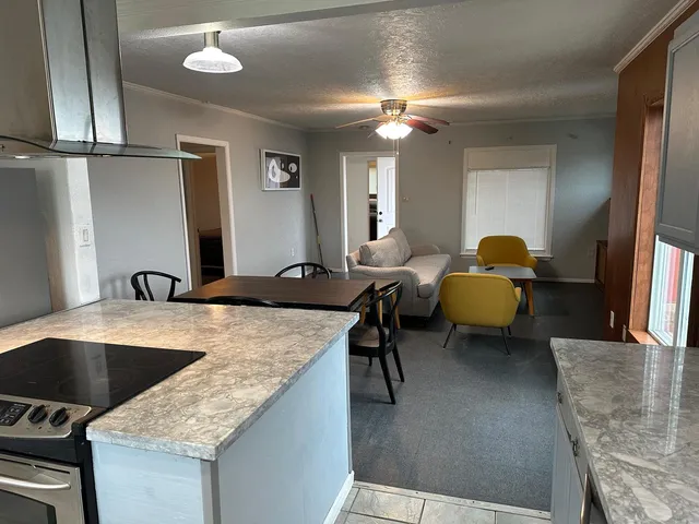 a bathroom with a granite countertop double vanity sink and a mirror