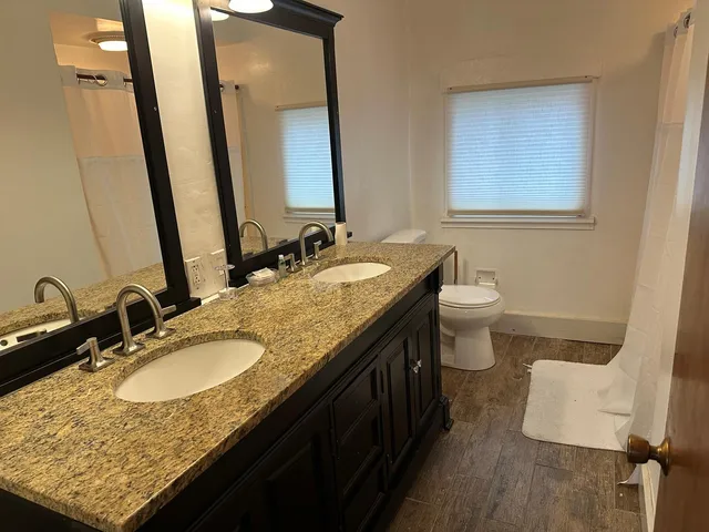 a bedroom with a bed and a lamp on the dresser