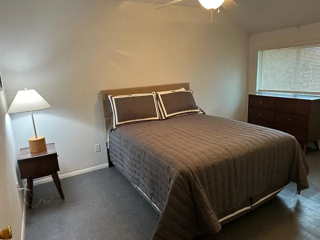 a bedroom with a bed and a mirror