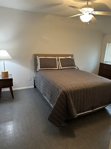 a bedroom with a bed and a window