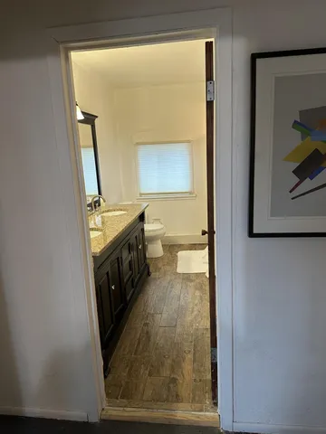 a view of walk in closet with hardwood