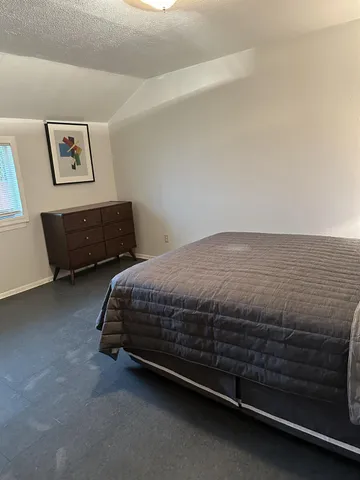 a bedroom with a bed and lamp