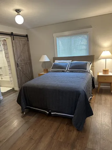 a view of a room with wooden floor and window