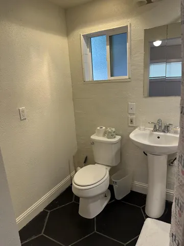 a bathroom with a granite countertop double vanity sink and a mirror