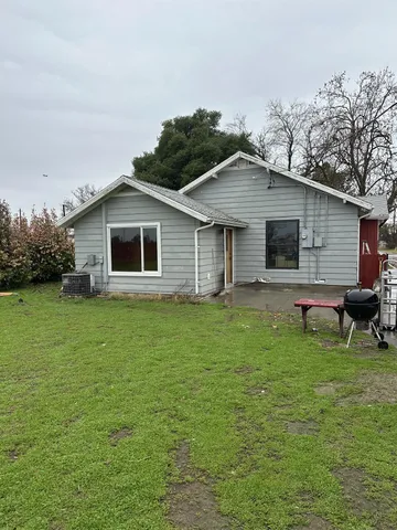 a view of a livingroom with furniture and chandelier fan