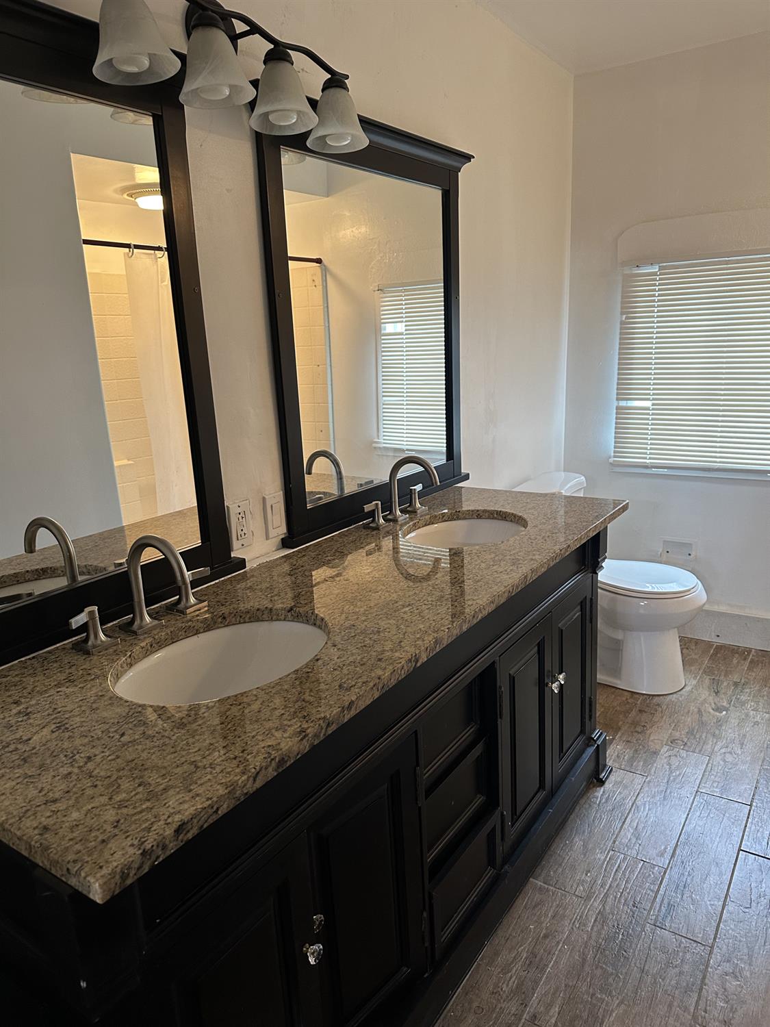 7271 Elk Grove Florin Road Sacramento, CA 95829 - Photo 46 of 49 a bathroom with a granite countertop double vanity sink and a mirror