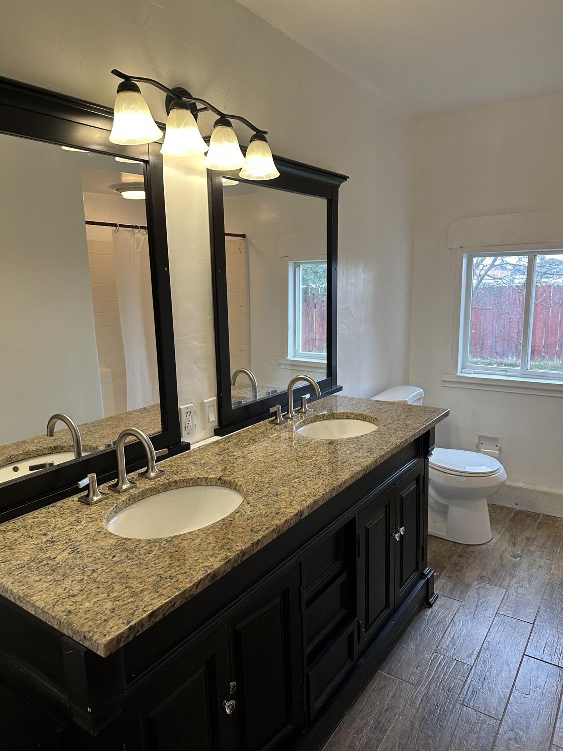 7271 Elk Grove Florin Road Sacramento, CA 95829 - Photo 47 of 49 a bathroom with a granite countertop sink and a mirror