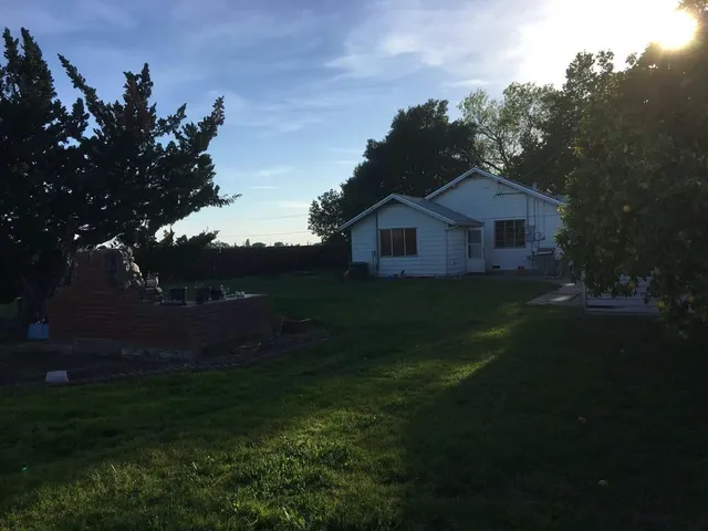 a bathroom with a granite countertop sink a mirror and bathtub