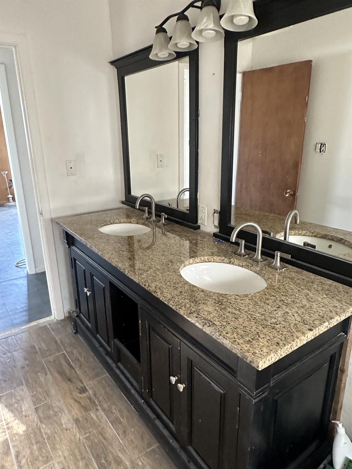 7271 Elk Grove Florin Road Sacramento, CA 95829 - Photo 7 of 49 a bathroom with a granite countertop sink a mirror and bathtub