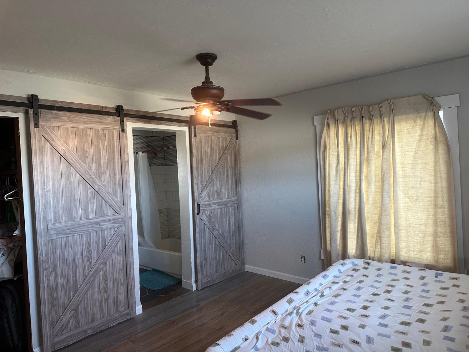 7271 Elk Grove Florin Road Sacramento, CA 95829 - Photo 9 of 49 a bedroom with a bed and a chandelier