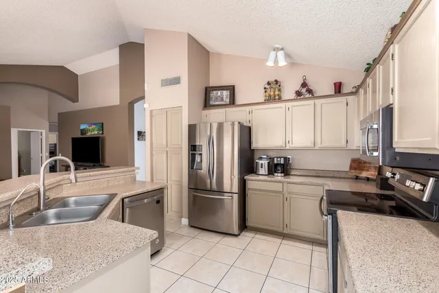 a kitchen with a sink and cabinets