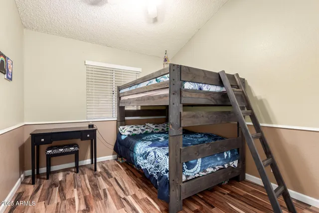 a bedroom with a bed and a mirror