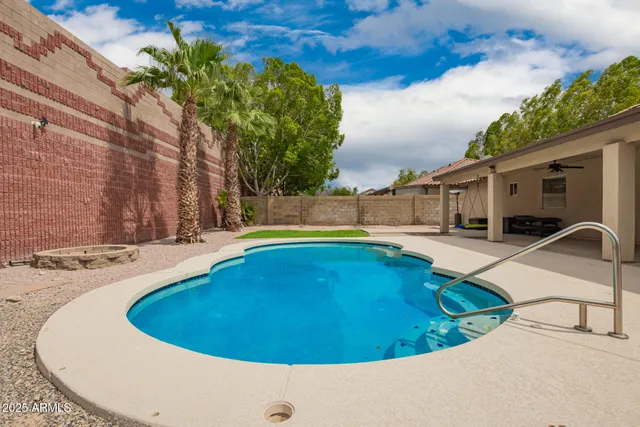 a view of a house with a yard and palm trees