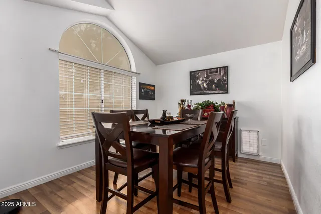 a view of a dining room with furniture and wooden floor