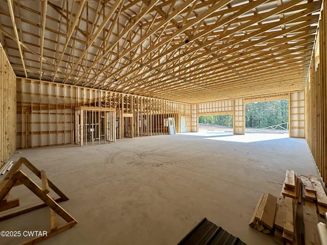a view of a yard with plants and trees