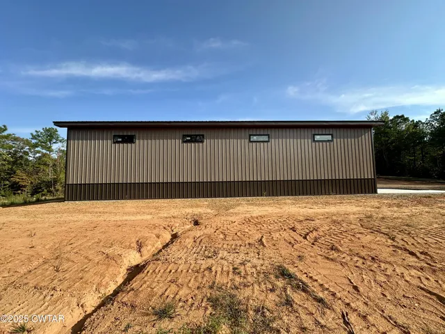 a view of wooden fence and a building