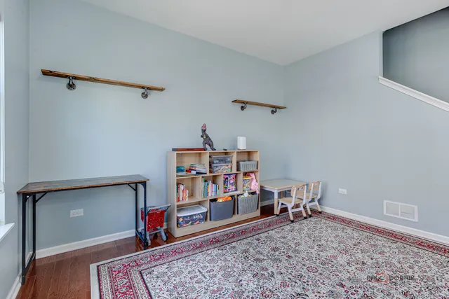 a living room with furniture and a book shelf