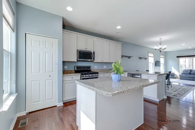 a kitchen with sink refrigerator and microwave