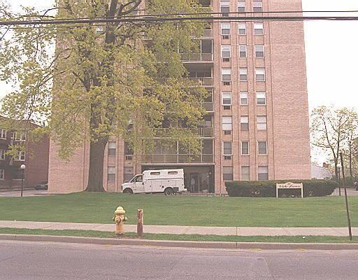 65 Glenbrook Road, Unit 9D Stamford, CT 06902 - Photo 1 of 1 a view of a brick building next to a yard