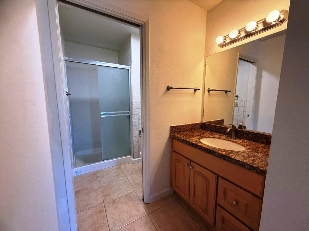 20072 Northcrest Square Cupertino, CA 95014 - Photo 11 of 26 a bathroom with a granite countertop sink and a mirror