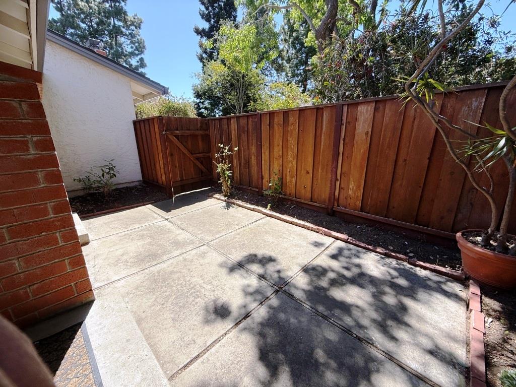 20072 Northcrest Square Cupertino, CA 95014 - Photo 16 of 26 a view of backyard with wooden fence and potted plants