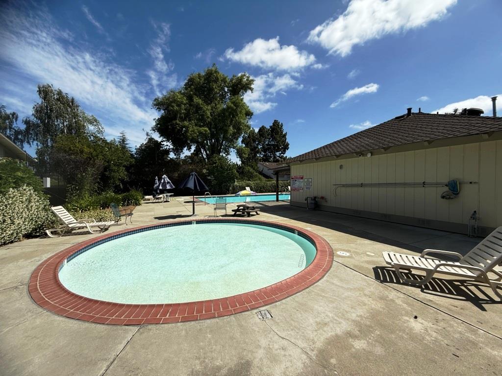 20072 Northcrest Square Cupertino, CA 95014 - Photo 21 of 26 a view of a swimming pool with a yard