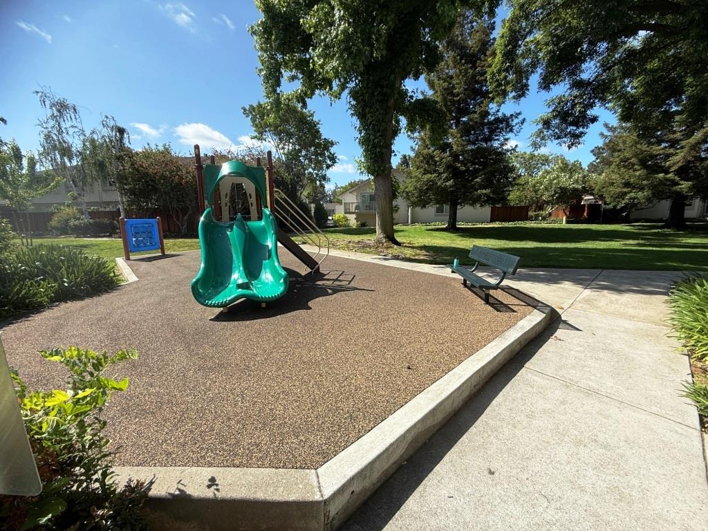 20072 Northcrest Square Cupertino, CA 95014 - Photo 22 of 26 a view of a lake with a bench and trees