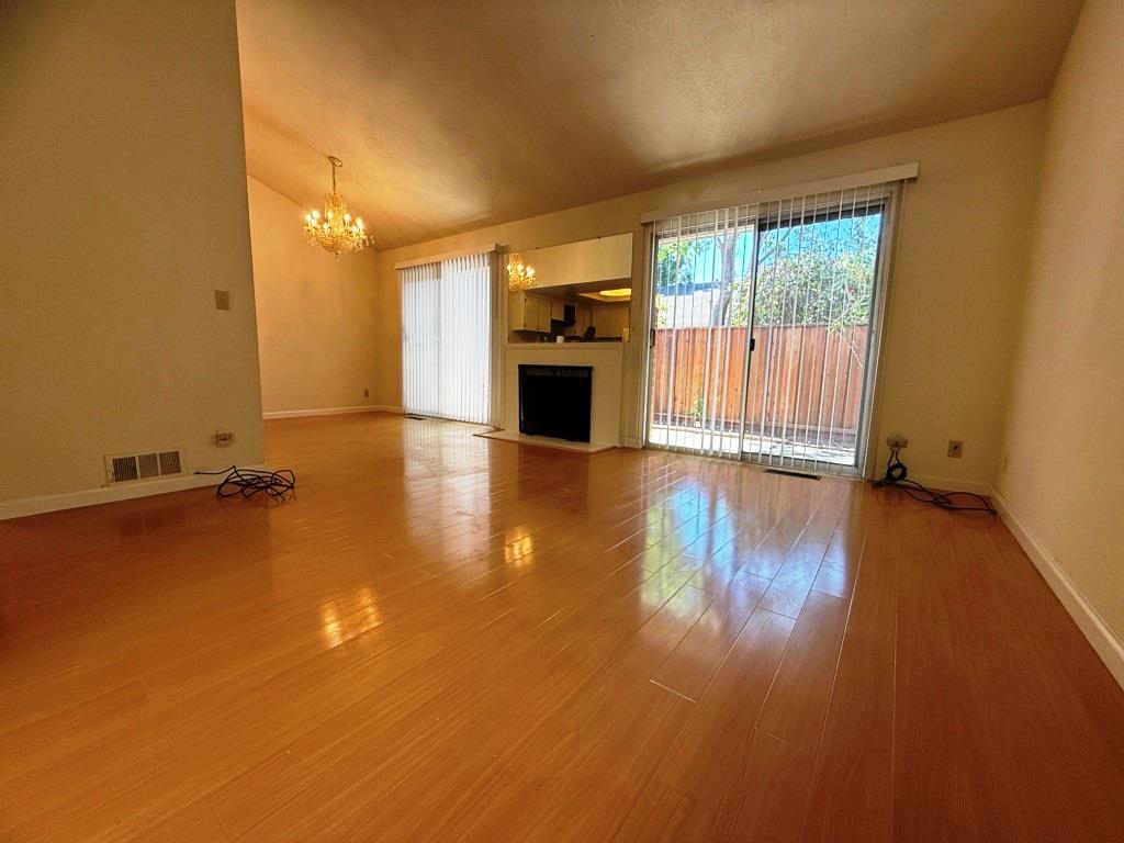 20072 Northcrest Square Cupertino, CA 95014 - Photo 5 of 26 a view of a livingroom with wooden floor and a fireplace