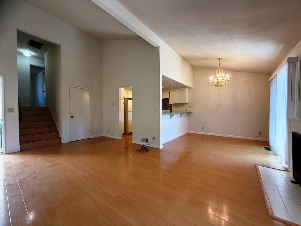 20072 Northcrest Square Cupertino, CA 95014 - Photo 6 of 26 an empty room with a kitchen and entryway
