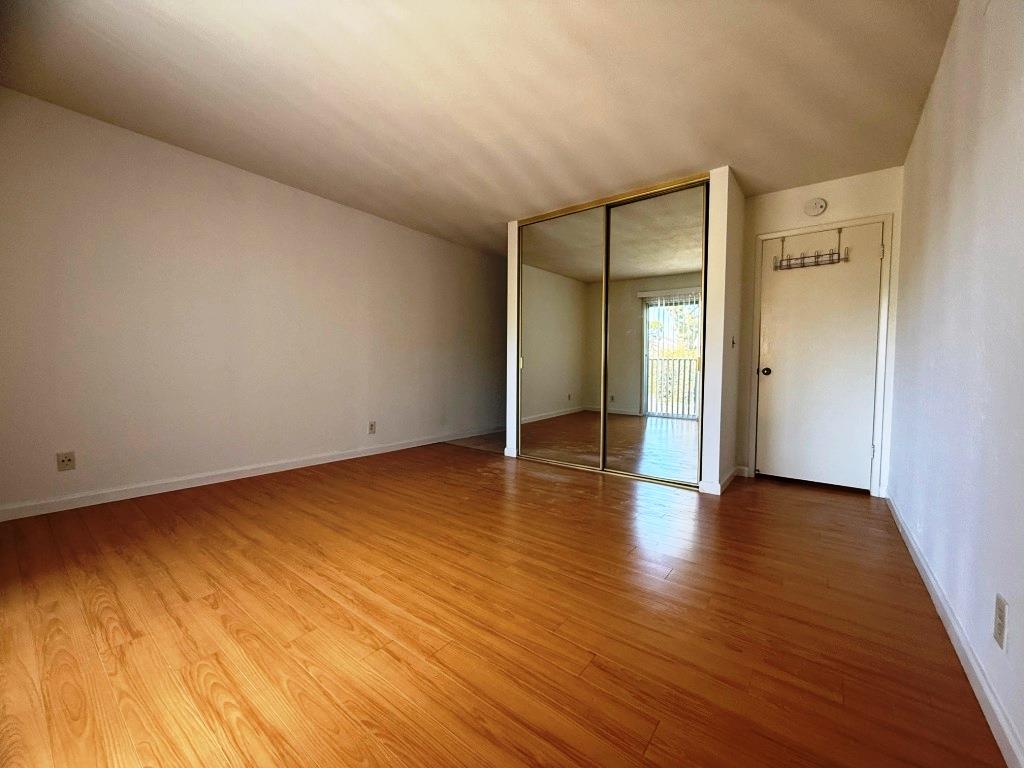 20072 Northcrest Square Cupertino, CA 95014 - Photo 10 of 26 a view of an empty room with wooden floor and a window