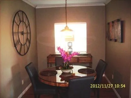 a dining room with furniture and a window