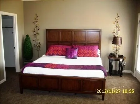 a bedroom with a bed and a lamp on table