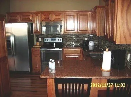 a kitchen with a refrigerator and cabinets
