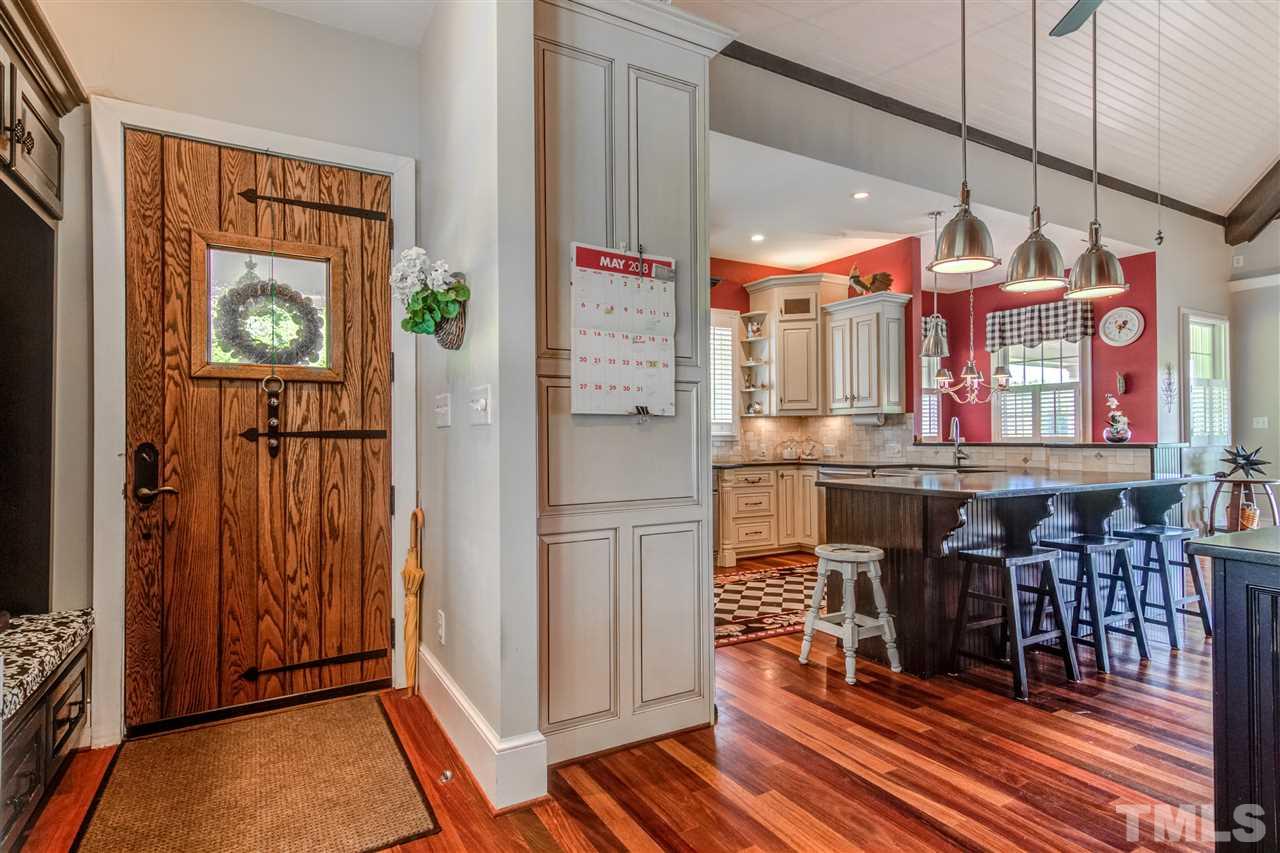 703 Kirk Adams Road Angier, NC 27501 - Photo 15 of 25 Come home through this trendy wood side door into the mudroom/office area. Large shelving with hooks for hanging coats and backpacks will stay with the house.