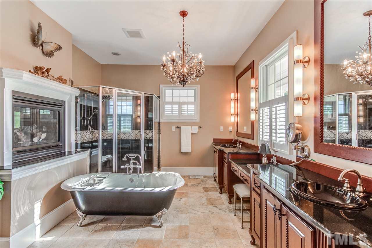703 Kirk Adams Road Angier, NC 27501 - Photo 18 of 25 Beautiful Master En Suite with plenty of counter space, large shower with multiple shower heads, and freestanding bathtub right next to the fireplace!