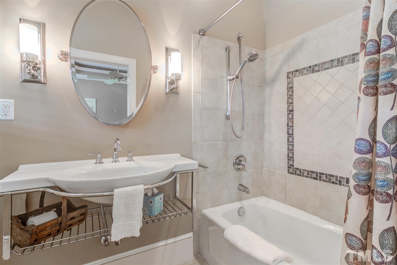 703 Kirk Adams Road Angier, NC 27501 - Photo 20 of 25 Second Bedroom Main level bathroom with tiled shower and trendy sink!