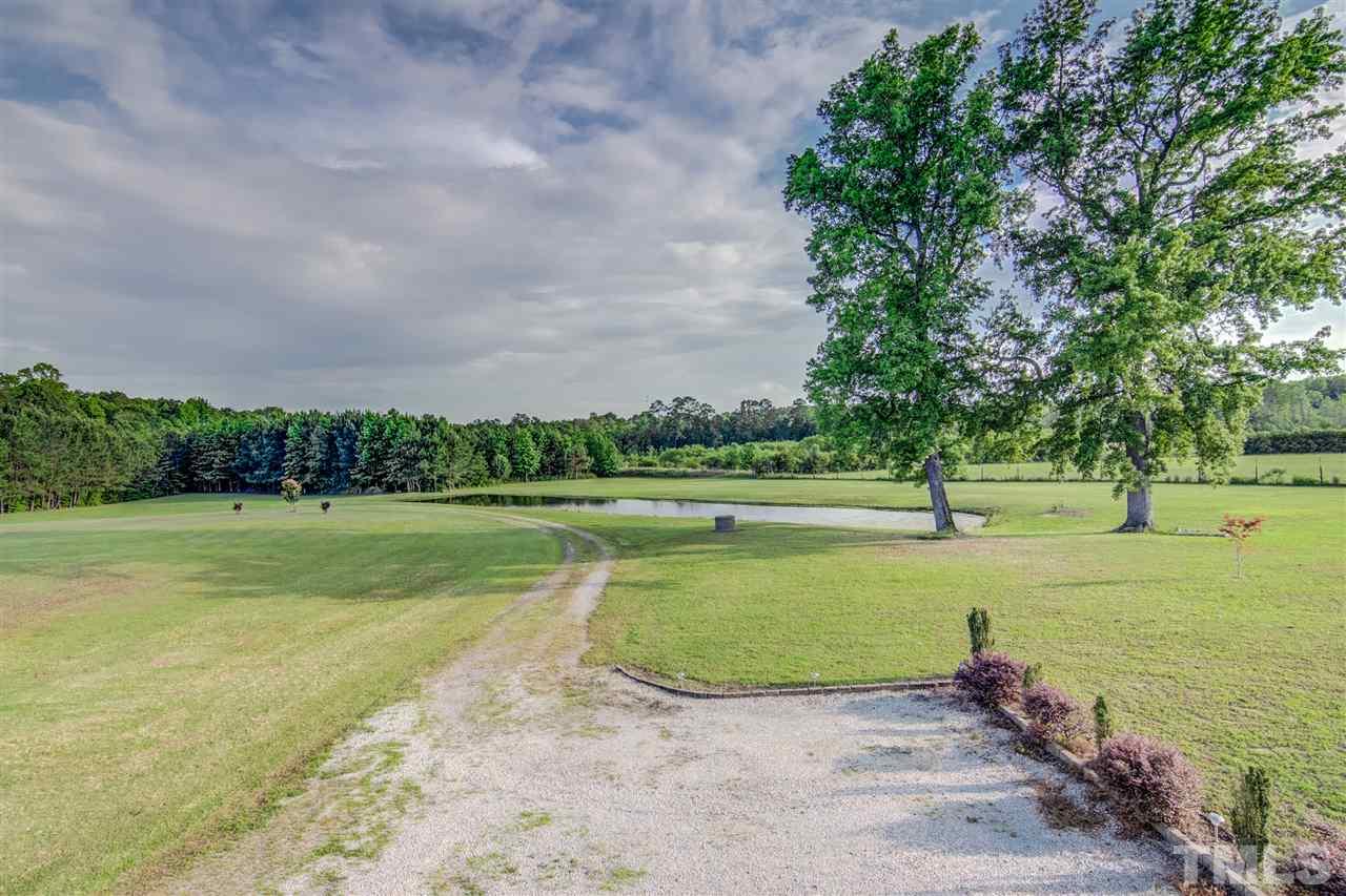 703 Kirk Adams Road Angier, NC 27501 - Photo 25 of 25 From the back of the home and garage, there is a little dirt road leading to the pond. This home is the perfect escape from the city life, while still being accessible to everything you need. Come see it today!