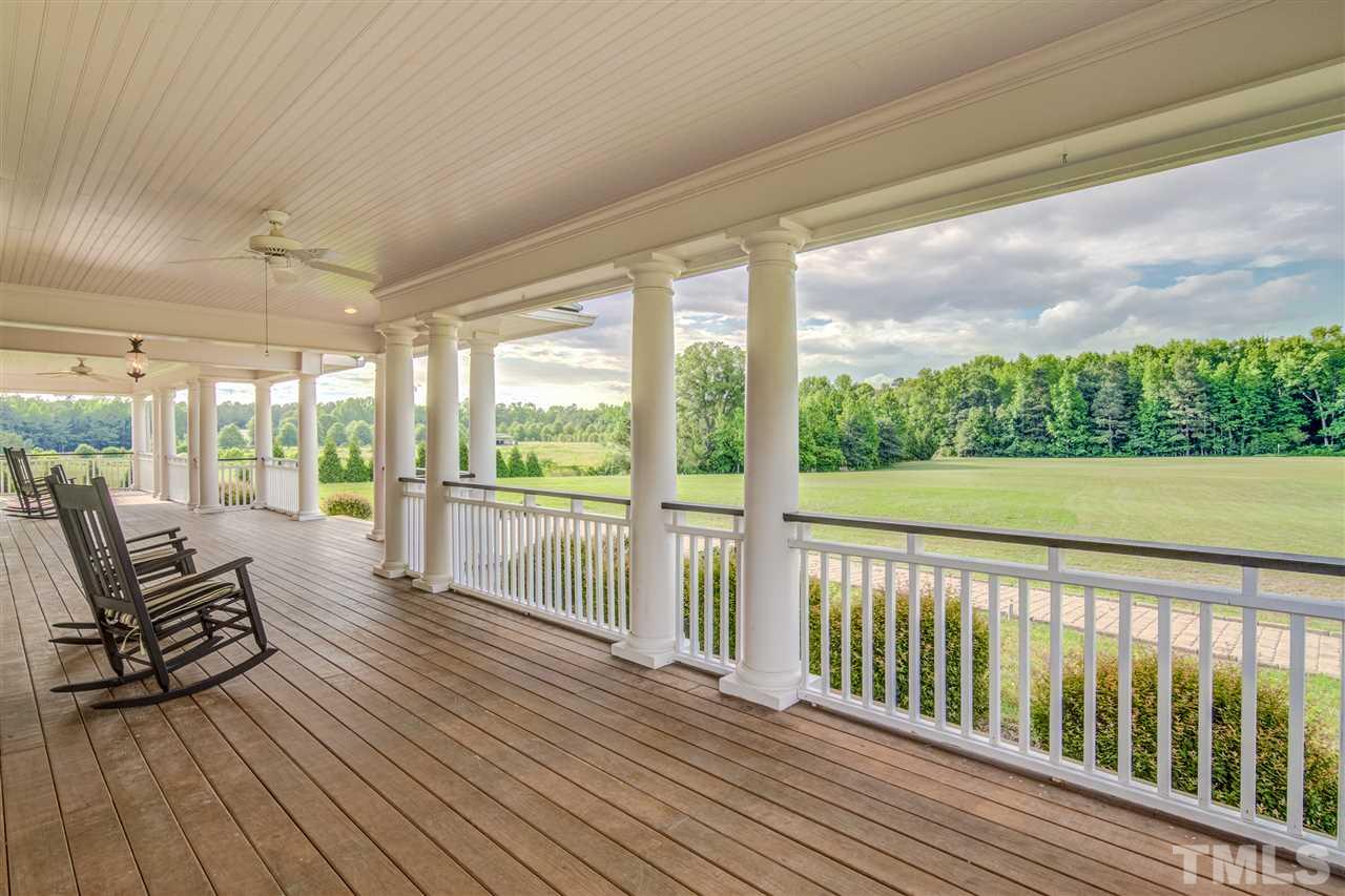 703 Kirk Adams Road Angier, NC 27501 - Photo 4 of 25 Almost 2,000 sqft of porch wraps completely around this home for a 360 view of this gorgeous estate.