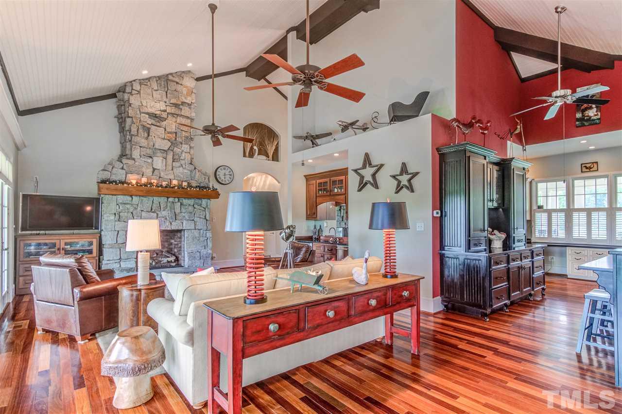 703 Kirk Adams Road Angier, NC 27501 - Photo 10 of 25 Hand-laid stone fireplace in the Main Level Family Room with Wet Bar that includes an ice maker and wine fridge.